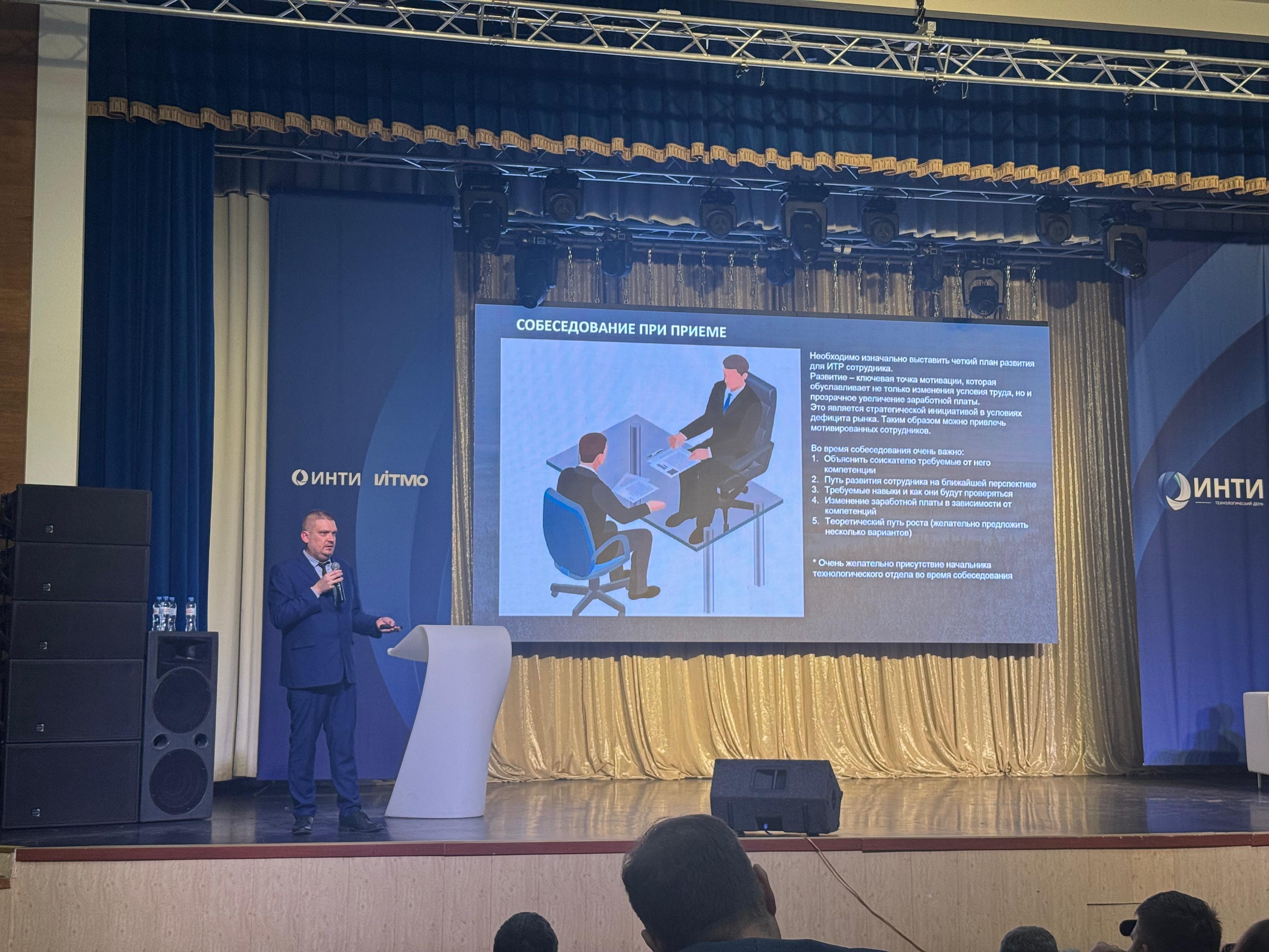 Speaker on stage during hiring interview slide